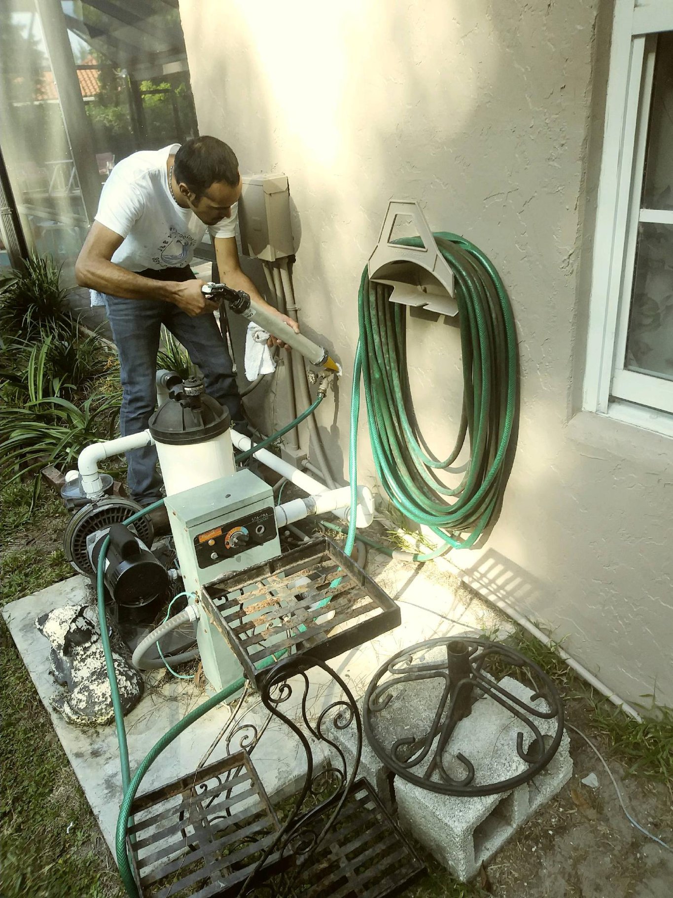 A man is working on the back of a house